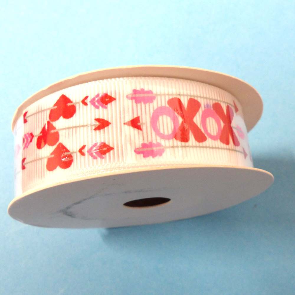 10 metres of white grosgrain ribbon with a Cupid Arrow Love Pink and Red Hearts and XOXO design size 22mm