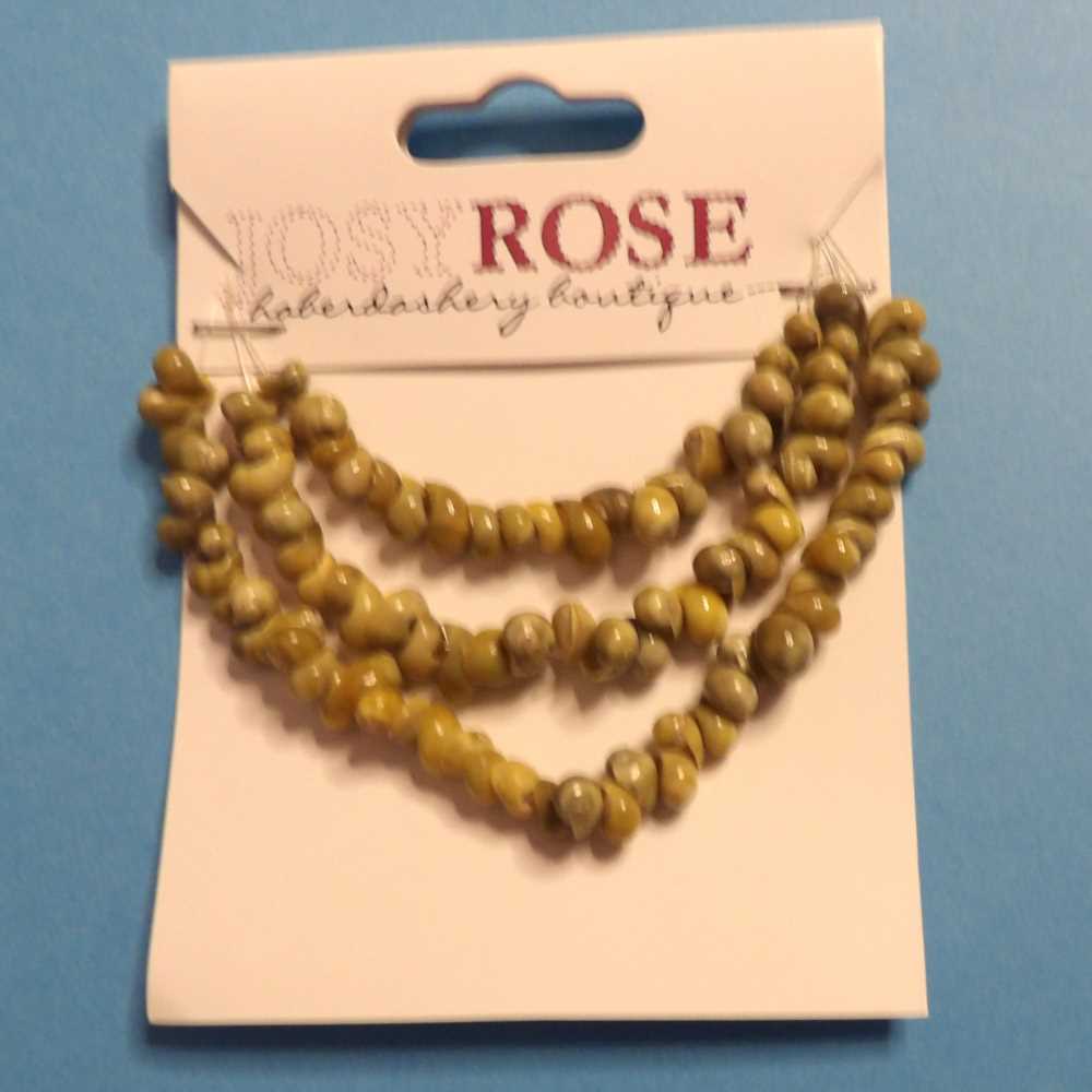 Card of small olive shell beads Josy Rose Brand