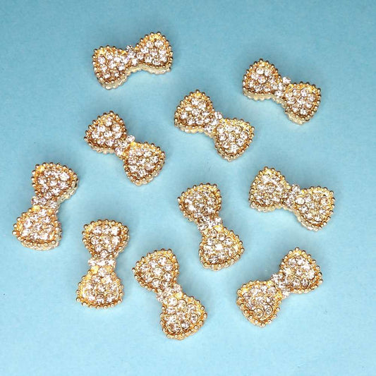 10 Bow shape diamante flat back size 24mm x 12mm with gold colour metal clearance