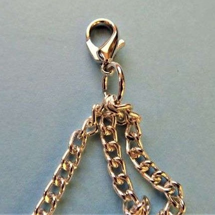 Silver colour trim with three 5mm chains with two large 12mm x 23mm fasteners 32cm long clearance