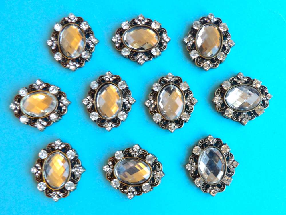 10 Oval diamante dark gold metal flat back with clear stone in centre trims size 30mm x 28mm clearance