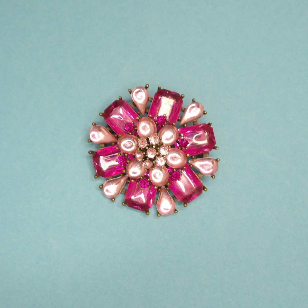Large metal brooch with pink and cerise type stones size 53mm clearance