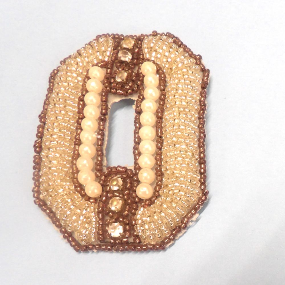 Silver beaded oval motif with white beads, small brown beads and diamante type stones size 85mm x 58mm clearance