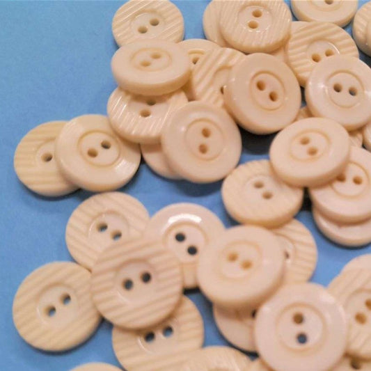 100 cream buttons with 2 holes and patterned edge size 14mm clearance