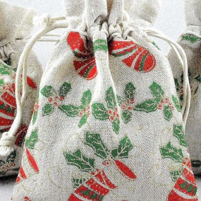 3 small draw string bags with holly leaf and stocking design size 13cm x 18cm