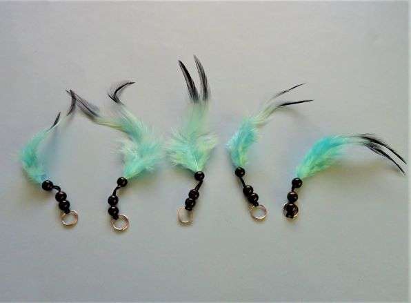 5 trims with  a small silver ring with 3 black 8mm beads and a turquoise feather 14cm long clearance